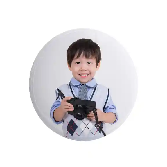 Young boy holding digital camera smiling