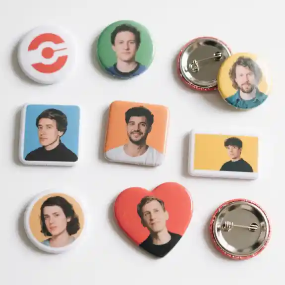 Collection of photo button pins with various portraits