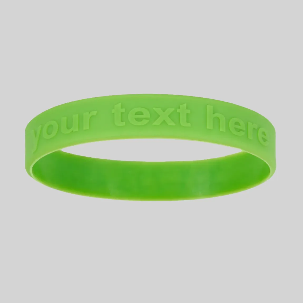A green silicone wristband with raised "YOUR TEXT HERE" embossed lettering.
