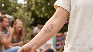 Semi-permanent floral tattoo on a forearm, illustrating a temporary tattoo design and its lasting appearance. 